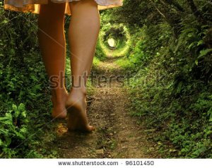 stock-photo-a-collage-of-two-images-showing-giant-female-legs-walking-onto-a-tunnel-like-forest-path-with-light-96101450